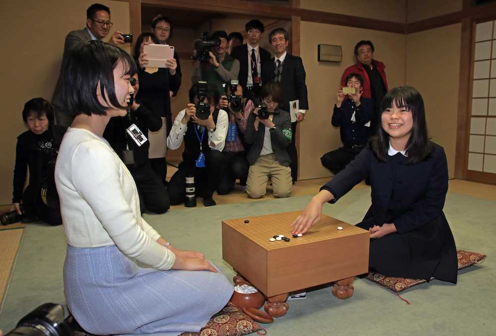 記者会見を終え、ポーズをとる上野梨紗さん。左は姉で女流棋聖の愛咲美さん