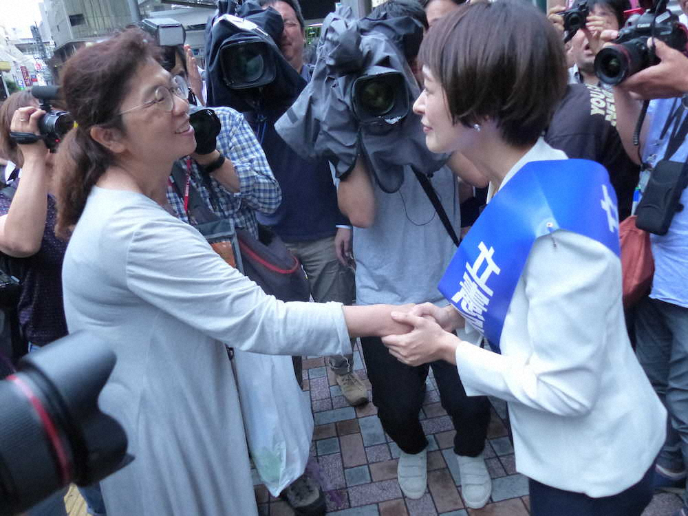 恵比寿駅の街頭で初の演説を行った市井紗耶香氏。「モーニング娘。」のファンだったという女性と握手を交わす