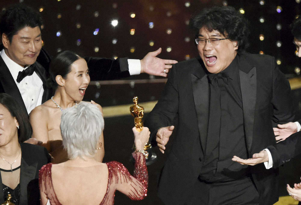 第92回米アカデミー賞で作品賞を受賞し、喜ぶ「パラサイト」のポン・ジュノ監督（右）と出演者ら（AP）