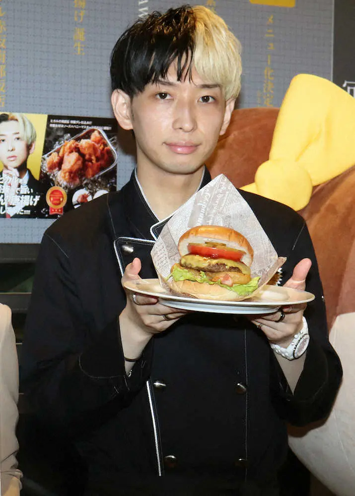 期間限定でオープンしたジョイフル渋谷・ヒカル店で、自ら考案したハンバーガーを手に笑顔のヒカル