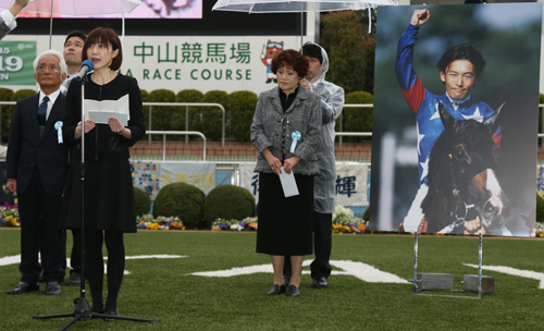 後藤さんの写真パネルの前でファンにあいさつする（左から）父・恒康さん、麻利絵夫人、母・聡子さん