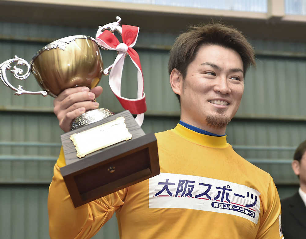 ２度目の記念制覇を果たした稲川がトロフィーを掲げる