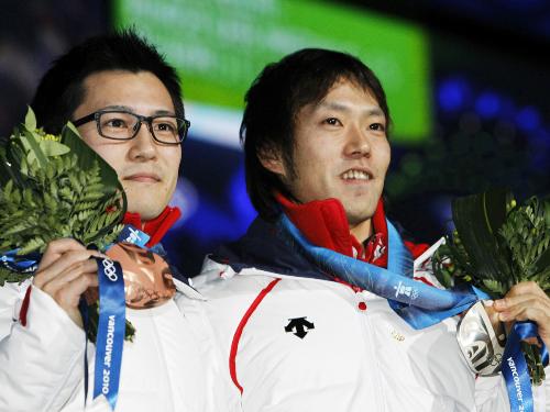 男子５００メートルの表彰式で、メダルを掲げる銅の加藤条治選手（左）と銀の長島圭一郎選手