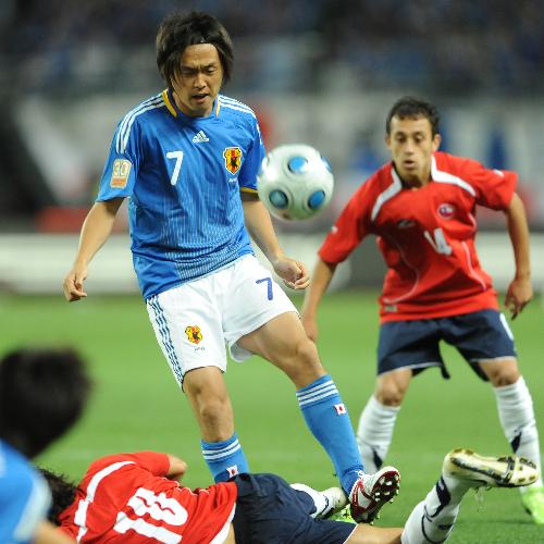 ＜日本・チリ＞前半、チリ選手のスライディングをかわし、浮き球のパスを出す遠藤保仁