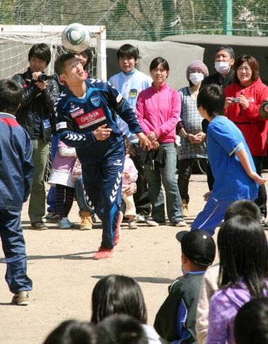 避難所を訪れ、子どもたちとリフティングゲームを楽しむ横浜ＦＣの三浦知良