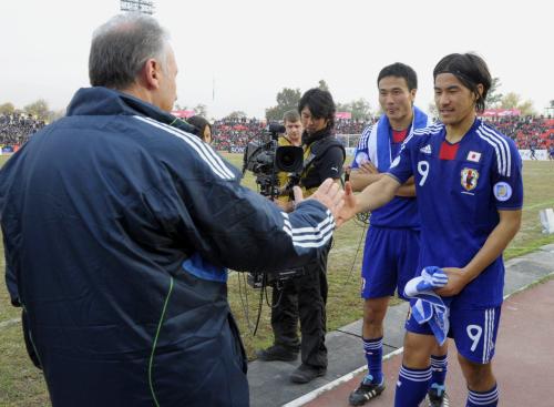 タジキスタンに勝利し、ザッケローニ監督（左）と握手する岡崎（９）。後方は今野
