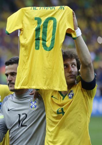 試合前、ネイマールのユニホームを掲げるブラジルのダビド・ルイス（ＡＰ）