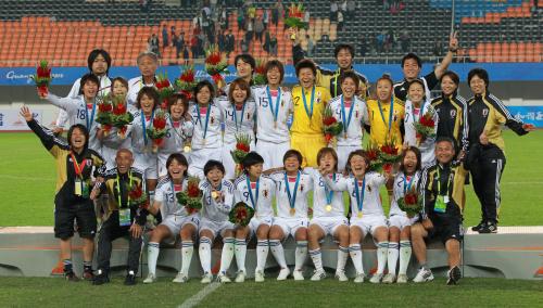 １０年１１月、アジア大会で優勝し記念写真におさまる澤（中段右から３人目）と辻上裕章氏（上段左）