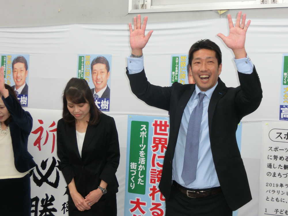 当選確実で万歳する元日本代表ＦＷの高松氏（左は美由紀夫人）