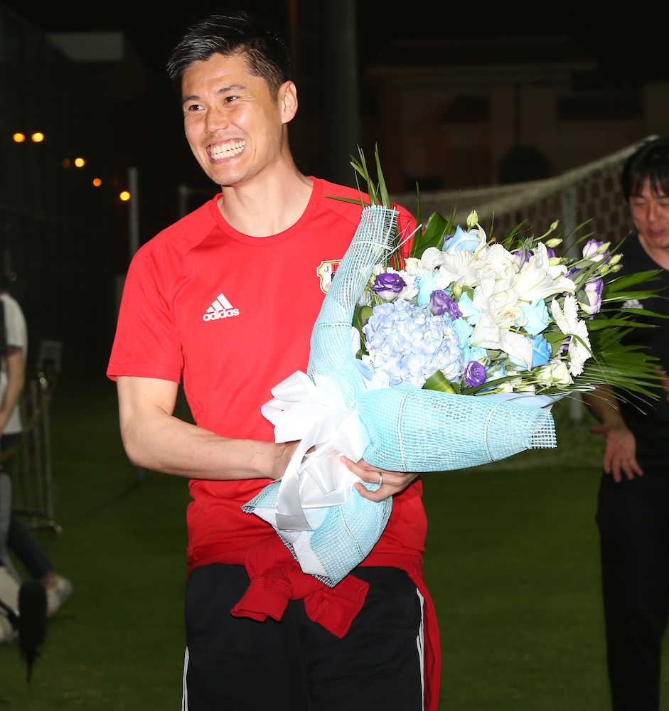 誕生日祝に報道陣から花束を受け取り笑顔を見せる川島