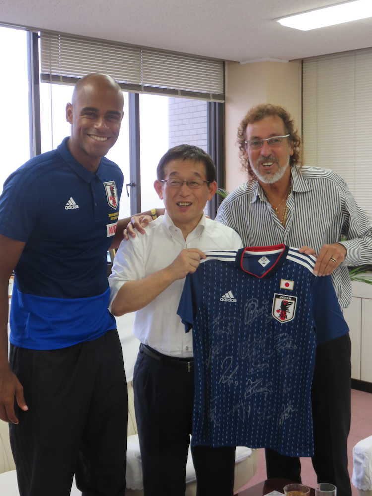 記念撮影をする（左から）茂怜羅オズ、明石市・泉社長、ラモス瑠偉・ビーチサッカー日本代表監督