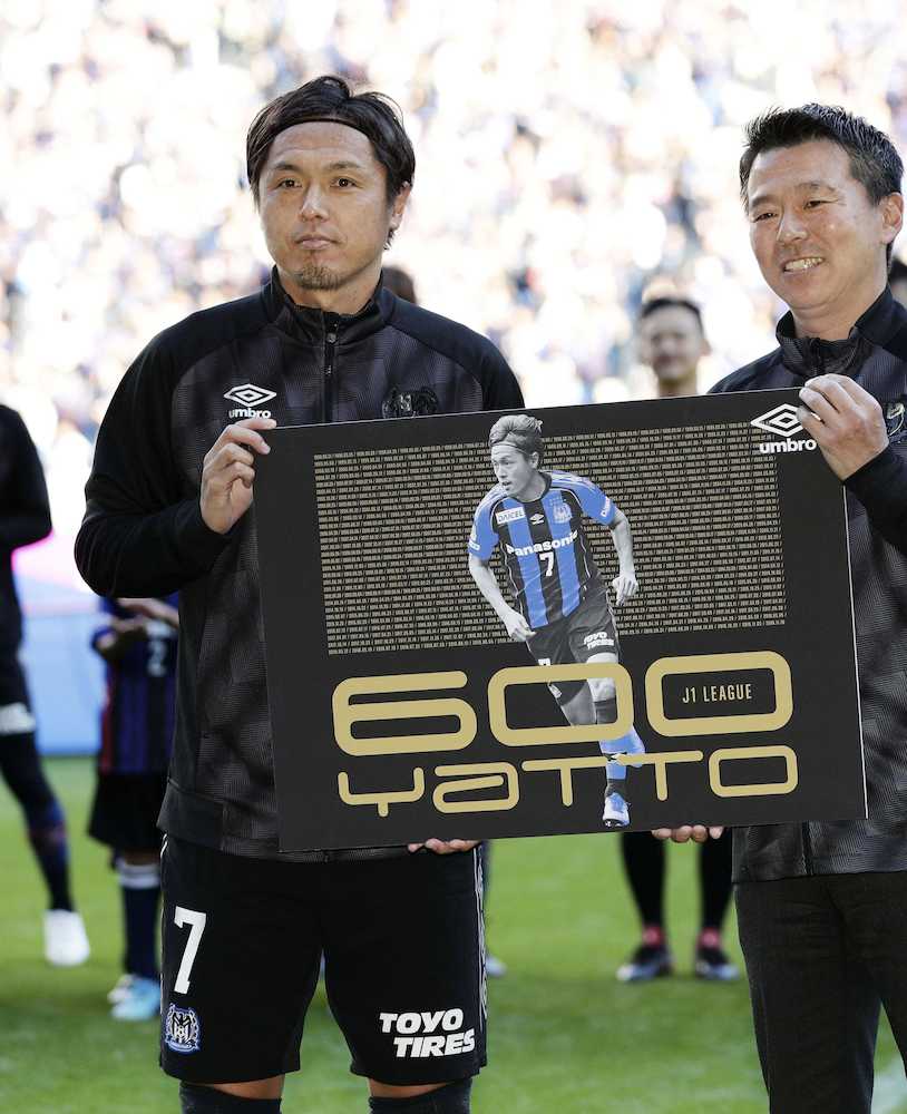 Ｊ１通算６００試合出場となる湘南戦を前に、記念のパネルを手にするＧ大阪・遠藤（左）