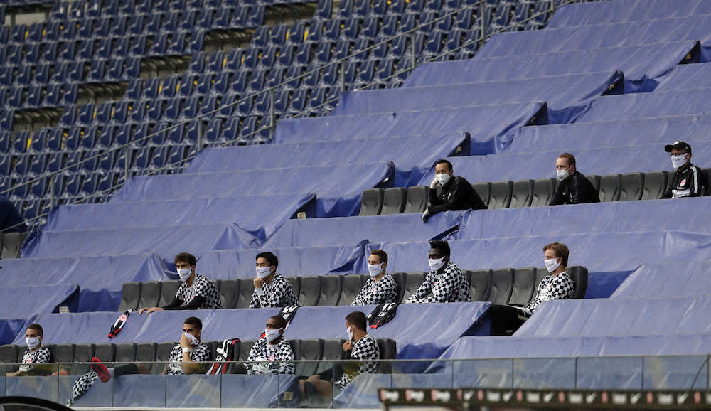 無人のスタンドで試合を見つめるEフランクフルトの控え選手たち。2列目の左から2人目が長谷部（AP）