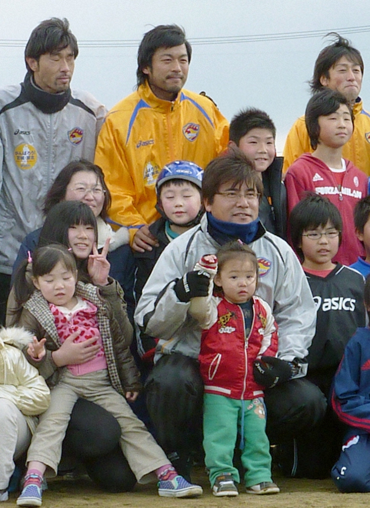 11年3月、宮城県石巻市の被災地を訪れ、子どもたちに囲まれる手倉森誠監督（前列中央右）