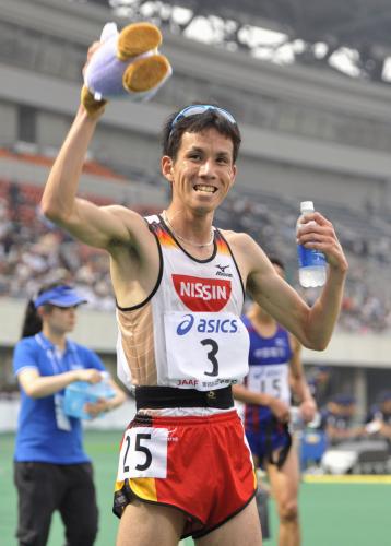 男子１万メートルで初優勝し、笑顔で声援に応える佐藤悠基