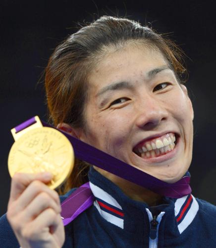 女子55キロ級で獲得した金メダルを手に笑顔を見せる吉田沙保里