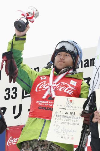男子デュアルモーグルで優勝し、表彰式でトロフィーを掲げる西伸幸