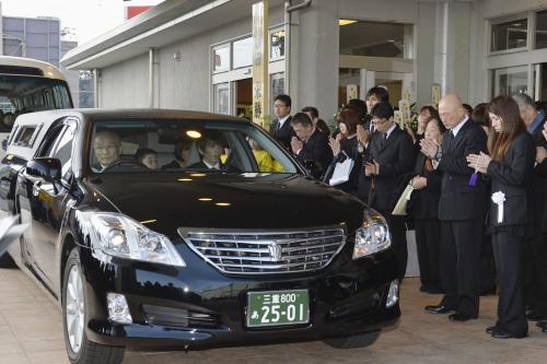吉田沙保里選手（右端）らに見送られ、葬儀所を出る栄勝さんのひつぎを乗せた車＝14日午後、津市