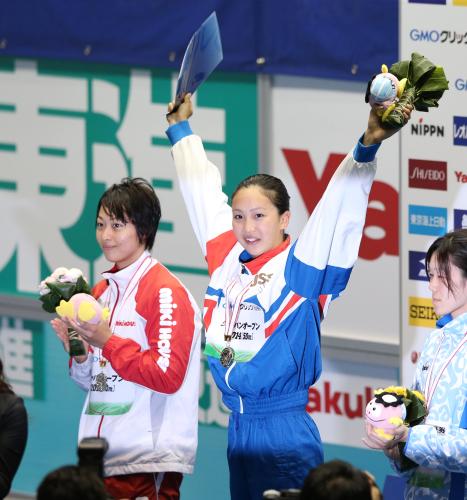 女子１００メートル平泳ぎで鈴木（左）の持つ日本記録を更新して優勝した渡部（中央）は表彰台で笑顔