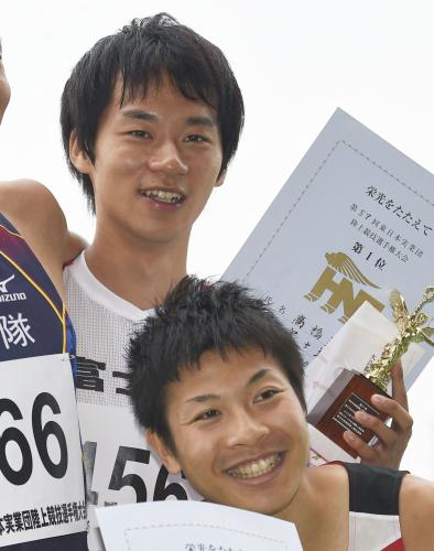 男子５０００メートル競歩で18分51秒93の日本新記録で優勝し、表彰式で笑顔の高橋英輝（奥）