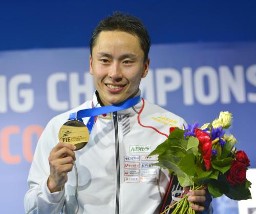 世界選手権の男子フルーレ個人で日本勢初の世界一となり、金メダルを手に笑顔の太田雄貴