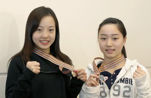 フィギュアスケートの世界ジュニア選手権から帰国し、メダルを手に笑顔の本田真凜（左）と樋口新葉
