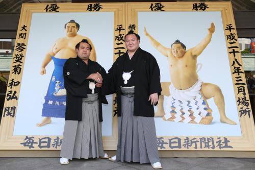 ＜大相撲優勝掲額・贈呈式＞国技館に飾られる優勝額を前に握手を交わす琴奨菊（左）と白鵬