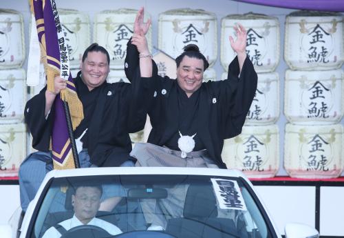 日馬富士は本割で白鵬を下し優勝を決めパレードで万歳（左は照ノ富士）
