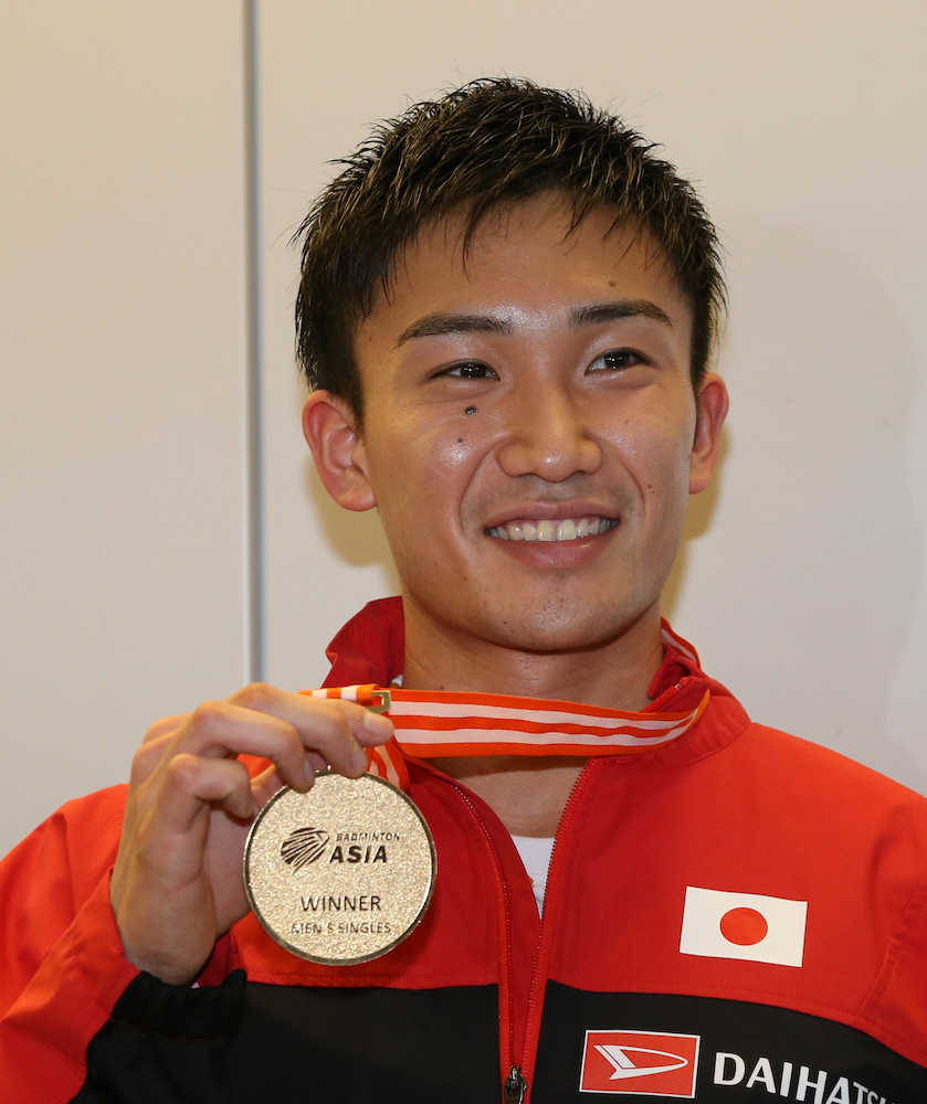 アジア選手権から帰国し、メダルを手に笑顔の桃田