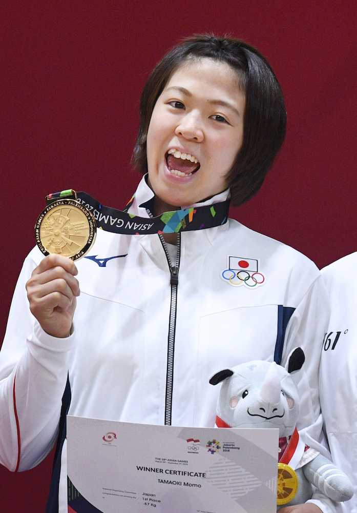 アジア大会女子５７キロ級で優勝し、表彰式で金メダルを手にする玉置桃