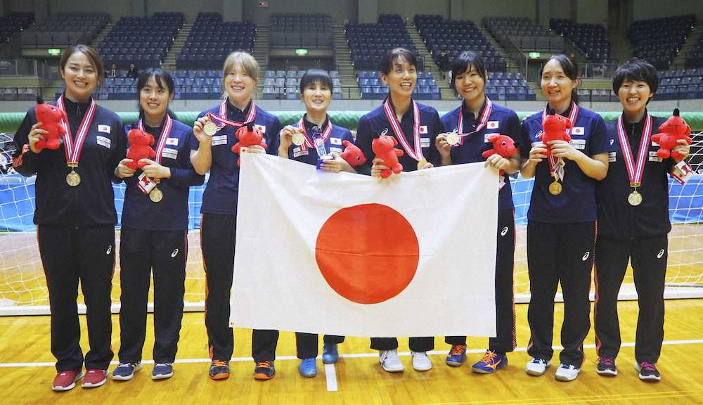 優勝し、金メダルを掲げる日本女子選手ら