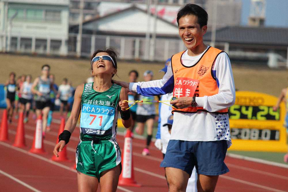 優勝し世界新記録更新を喜ぶ道下（左）と伴走者の志田さん