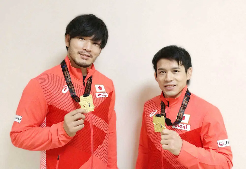 レスリングの東京五輪世界最終予選で1位になり、メダルを掲げる男子フリー86キロ級の高谷惣亮（左）と57キロ級の高橋侑希（日本レスリング協会提供）