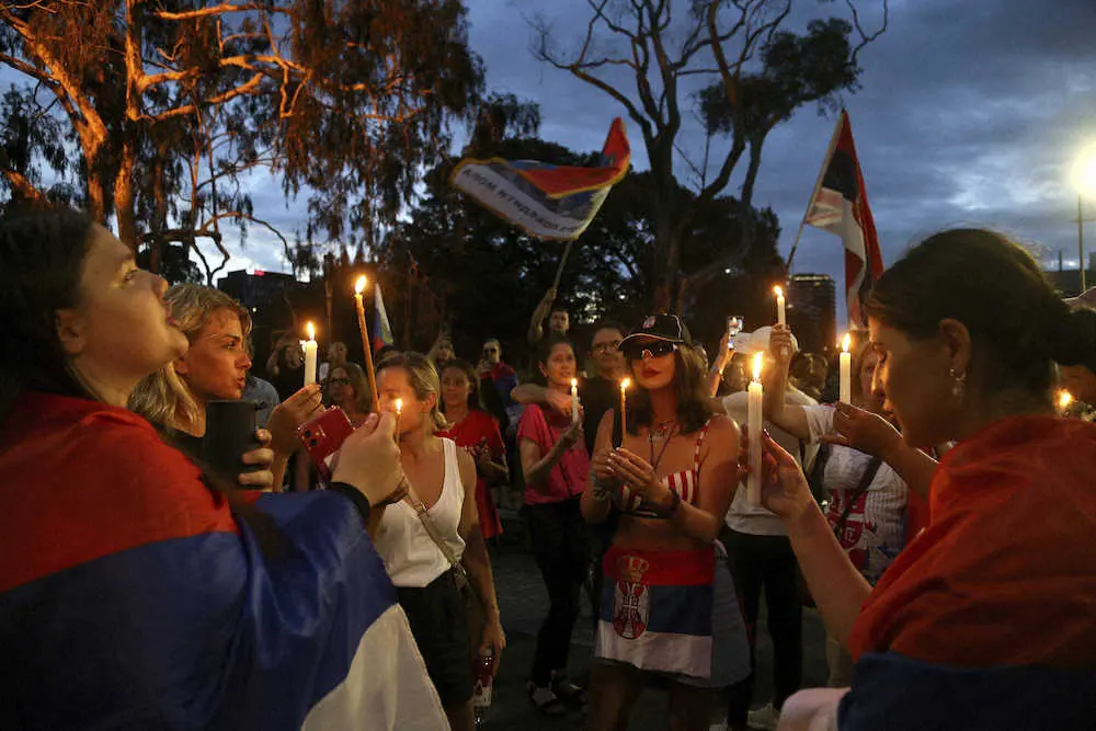 全豪オープン出場を願うジョコビッチのファン達が宿泊施設の近くでロウソクを灯し、オーストラリア政府へ対し抗議する（AP）