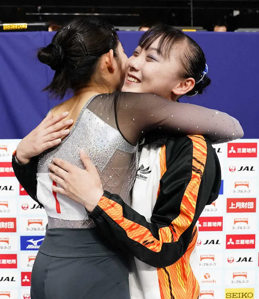 女子個人総合で2位の笠原有彩（左）と抱き合う優勝した宮田笙子
